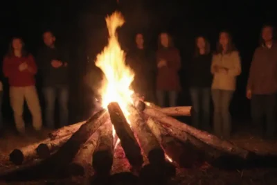 Diversos grupos celebrando San Juans Eva con hogueras festivas y rituales tradicionales.