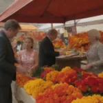 Establo de mercado con vibrantes marigolds con señalización y clientes atractivos.
